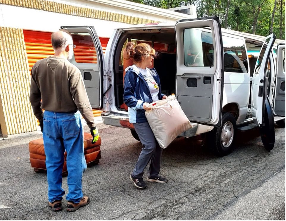 man and woman loading home furnishings into van